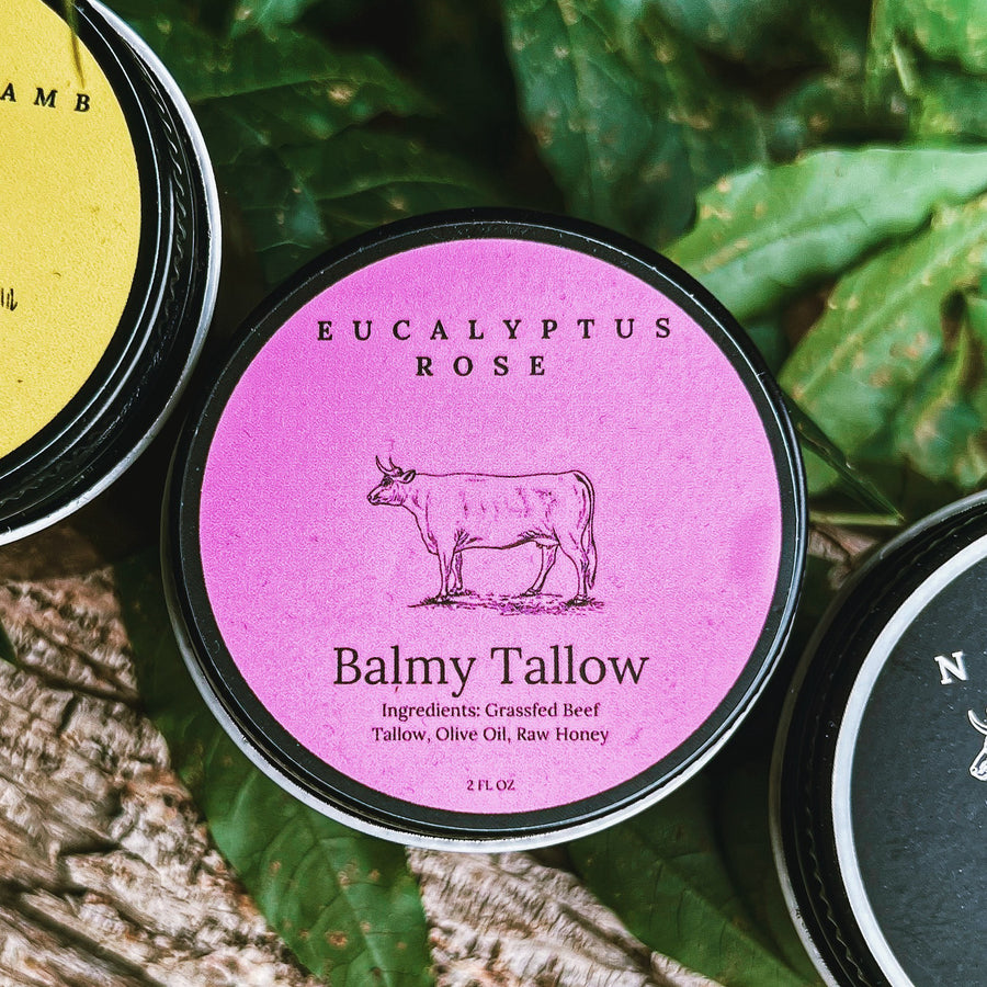 Container of Balmy Tallow with Eucalyptus Rose label on a natural background