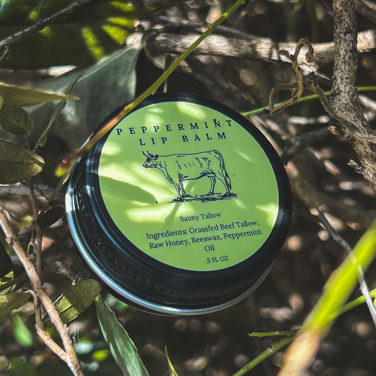 Peppermint lip balm container with green label on a natural background